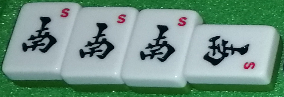 A called open kan. The tiles pictured are the four Nan tiles.